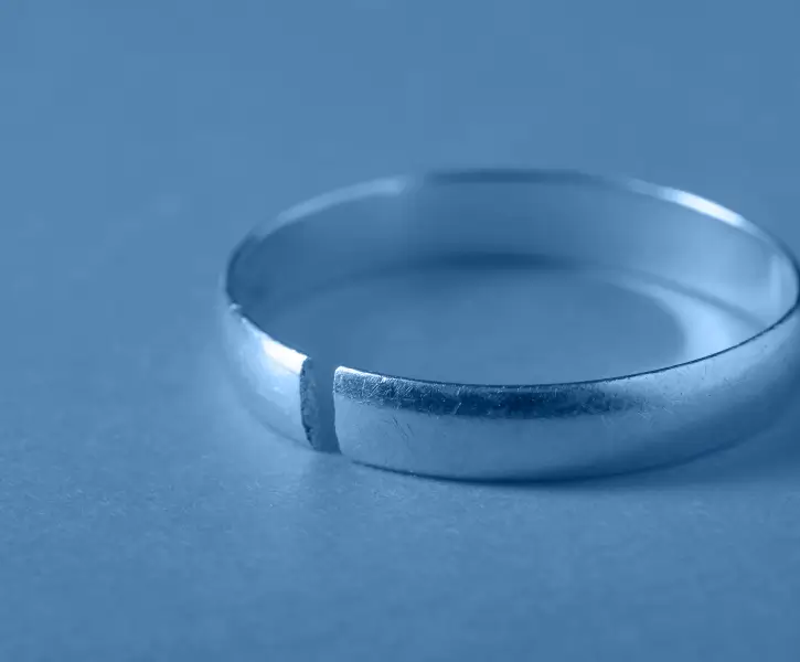 a close up of a wedding ring on a blue background