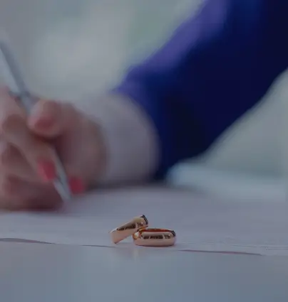 a pair of gold wedding rings sitting on top of a table